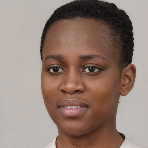 Joyful black young-adult female with short  brown hair and brown eyes