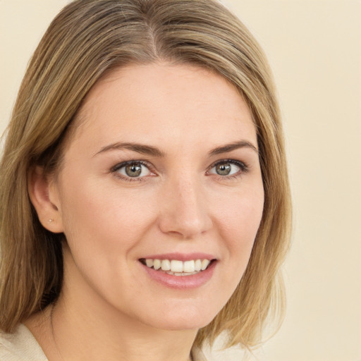 Joyful white young-adult female with medium  brown hair and brown eyes