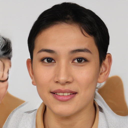 Joyful asian young-adult female with medium  brown hair and brown eyes