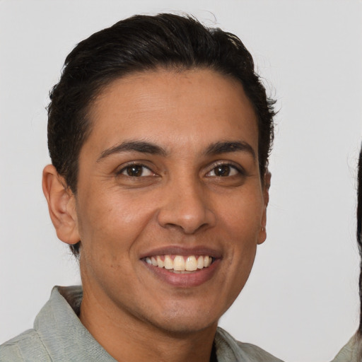 Joyful latino young-adult female with short  brown hair and brown eyes