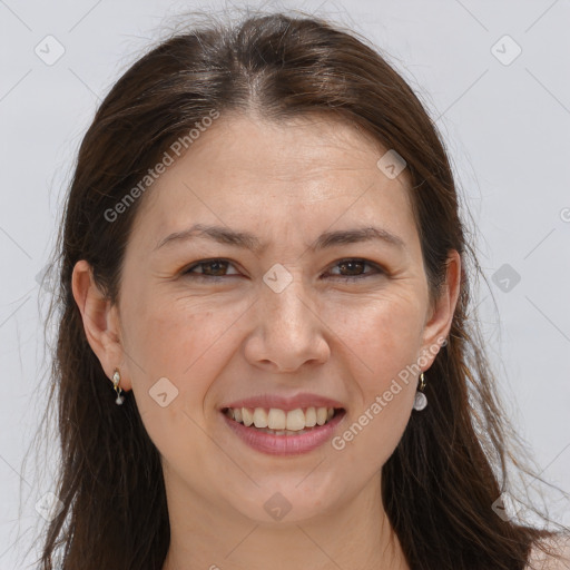 Joyful white adult female with long  brown hair and brown eyes