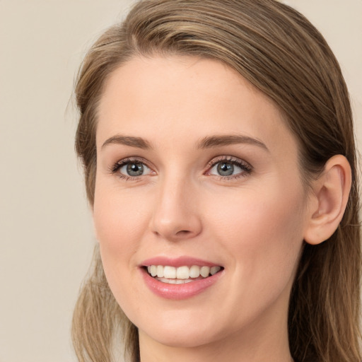 Joyful white young-adult female with long  brown hair and blue eyes