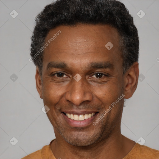 Joyful black adult male with short  black hair and brown eyes