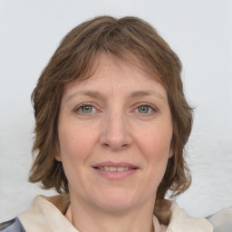 Joyful white adult female with medium  brown hair and grey eyes