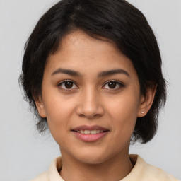 Joyful latino young-adult female with medium  brown hair and brown eyes