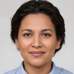 Joyful white adult female with medium  brown hair and brown eyes