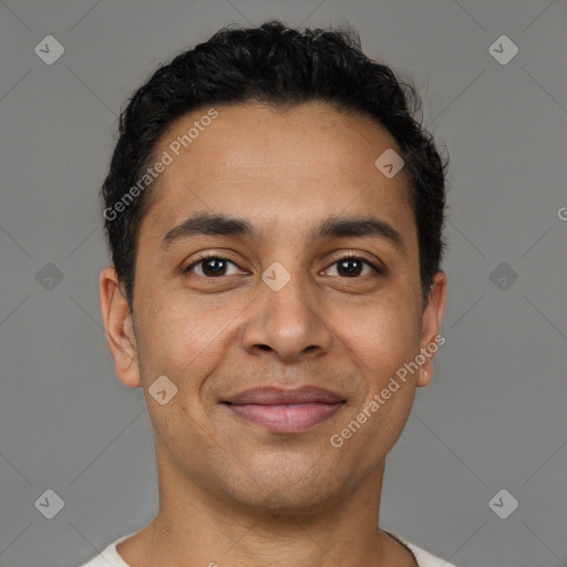 Joyful latino young-adult male with short  brown hair and brown eyes