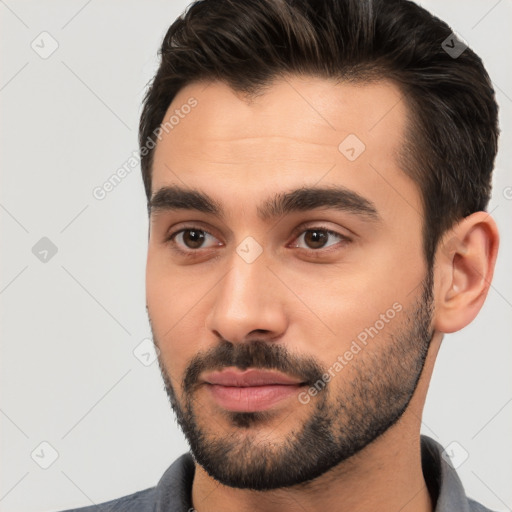 Joyful white young-adult male with short  black hair and brown eyes