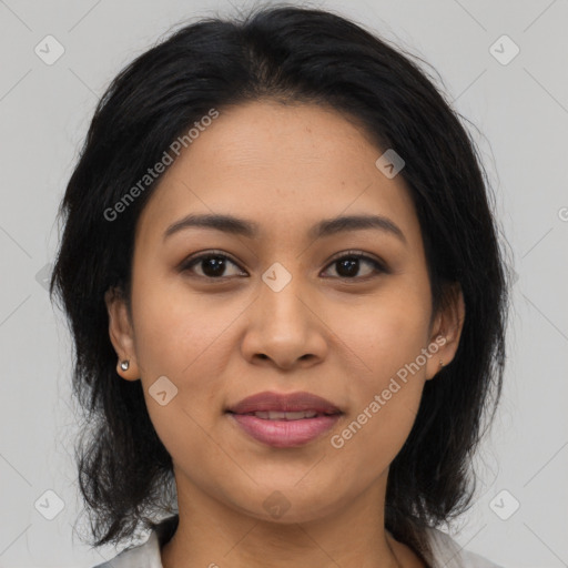 Joyful latino young-adult female with medium  brown hair and brown eyes