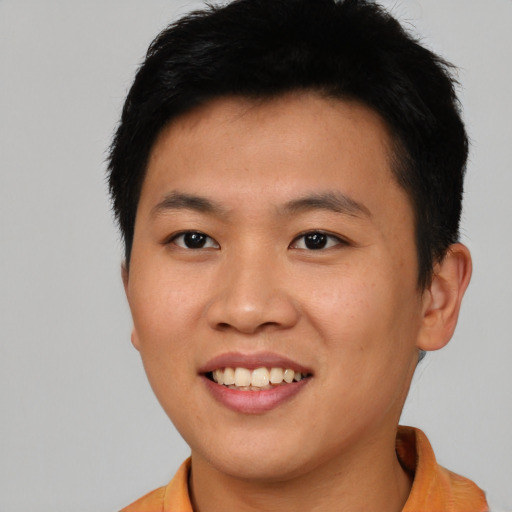 Joyful asian young-adult male with short  brown hair and brown eyes