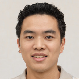 Joyful asian young-adult male with short  black hair and brown eyes