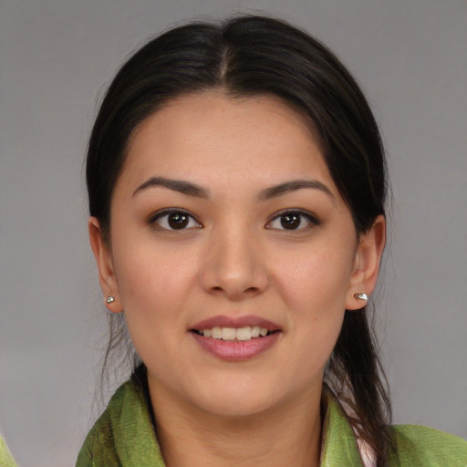 Joyful latino young-adult female with medium  brown hair and brown eyes