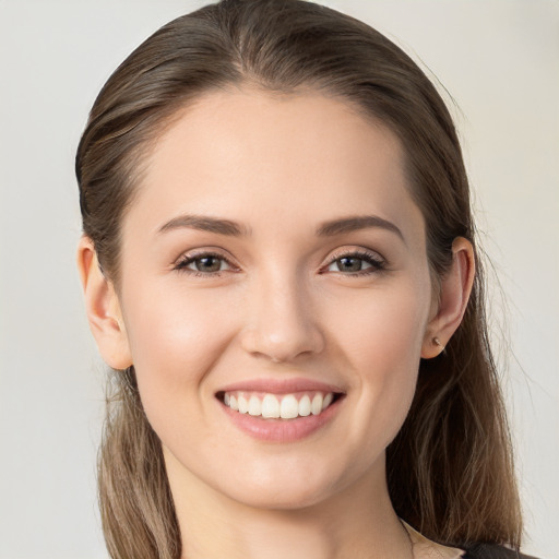 Joyful white young-adult female with long  brown hair and grey eyes