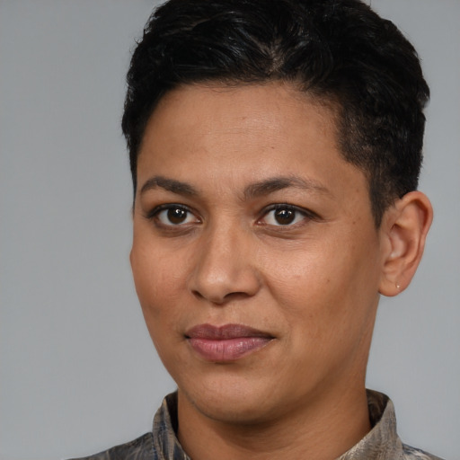 Joyful latino young-adult female with short  black hair and brown eyes