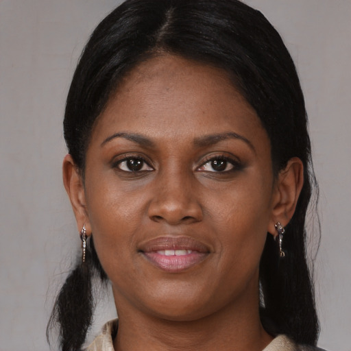 Joyful black young-adult female with medium  black hair and brown eyes