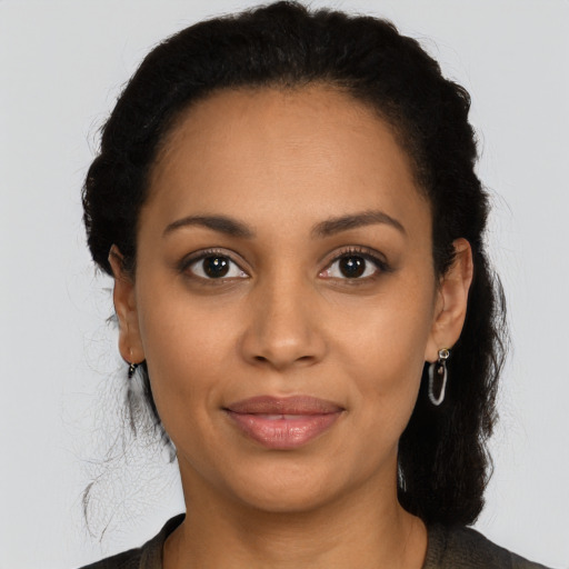 Joyful latino young-adult female with long  brown hair and brown eyes
