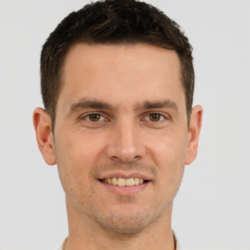 Joyful white young-adult male with short  brown hair and brown eyes