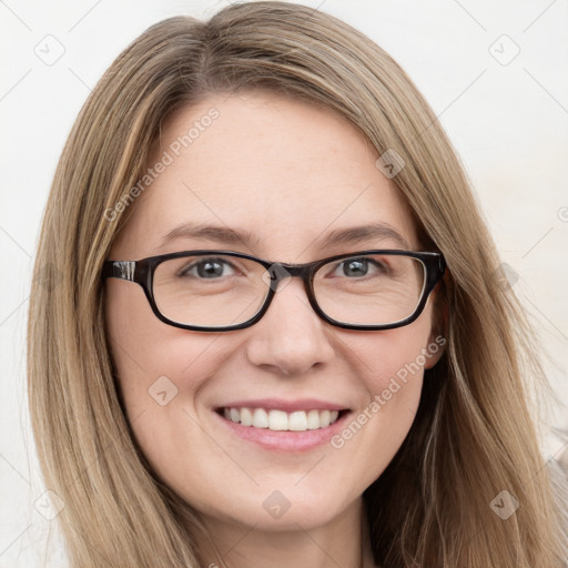 Joyful white young-adult female with long  brown hair and blue eyes