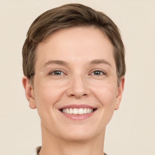 Joyful white young-adult female with short  brown hair and grey eyes