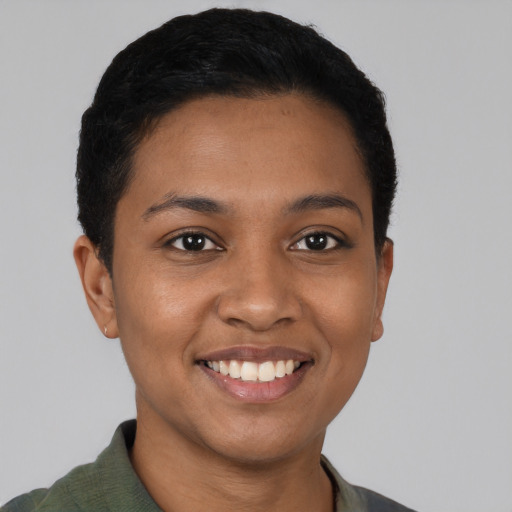 Joyful latino young-adult female with short  black hair and brown eyes