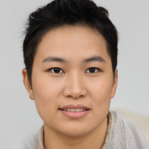 Joyful asian young-adult female with short  brown hair and brown eyes