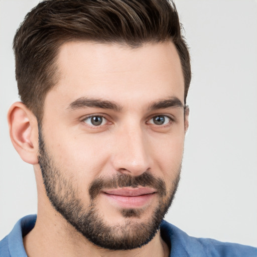 Joyful white young-adult male with short  brown hair and brown eyes