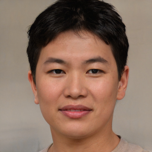 Joyful asian young-adult male with short  brown hair and brown eyes