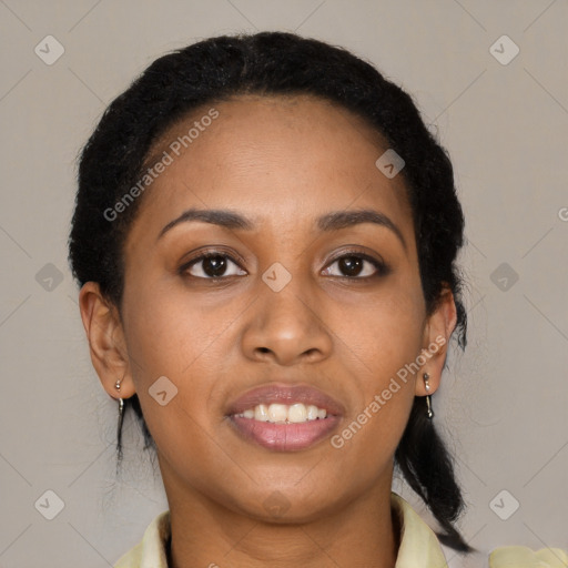 Joyful black young-adult female with long  brown hair and brown eyes