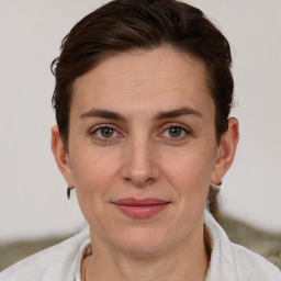 Joyful white adult female with short  brown hair and brown eyes