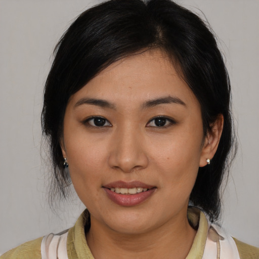 Joyful asian young-adult female with medium  black hair and brown eyes