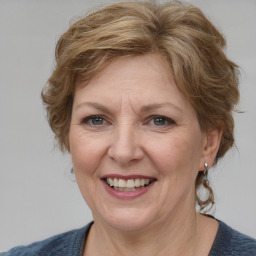 Joyful white adult female with medium  brown hair and blue eyes