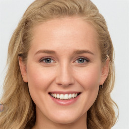 Joyful white young-adult female with long  brown hair and blue eyes