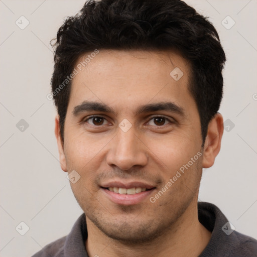 Joyful white young-adult male with short  black hair and brown eyes