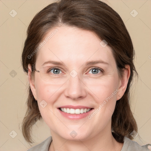 Joyful white young-adult female with medium  brown hair and blue eyes