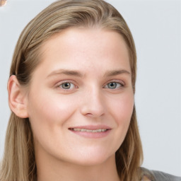 Joyful white young-adult female with long  brown hair and blue eyes