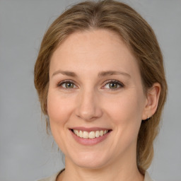 Joyful white adult female with medium  brown hair and blue eyes