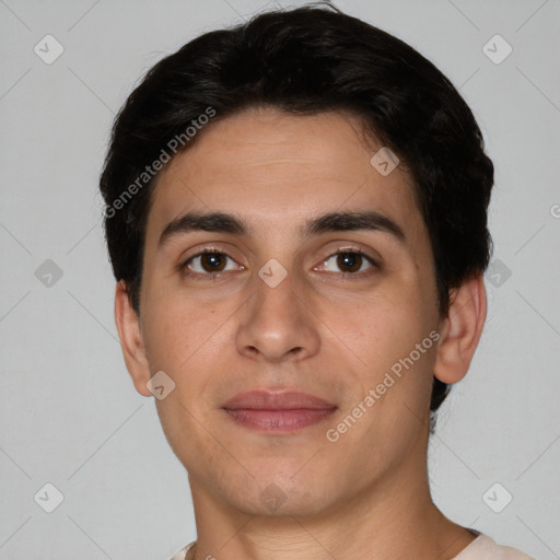 Joyful white young-adult male with short  black hair and brown eyes