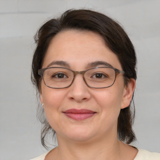 Joyful white adult female with medium  brown hair and brown eyes