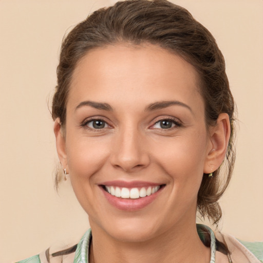 Joyful white young-adult female with long  brown hair and brown eyes