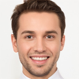 Joyful white young-adult male with short  brown hair and brown eyes