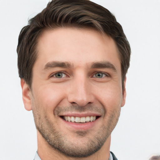 Joyful white young-adult male with short  brown hair and grey eyes