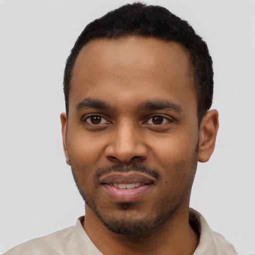 Joyful black young-adult male with short  black hair and brown eyes