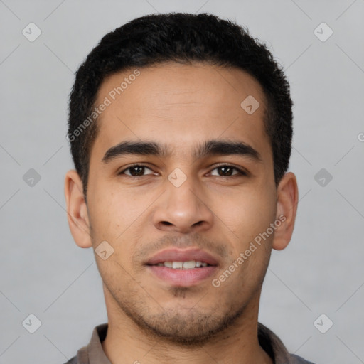 Joyful latino young-adult male with short  brown hair and brown eyes