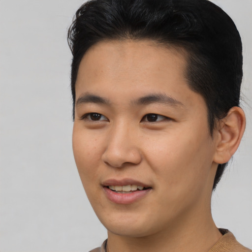 Joyful asian young-adult male with short  brown hair and brown eyes