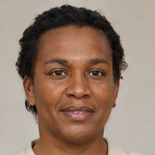 Joyful black adult female with short  brown hair and brown eyes