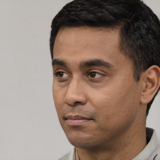 Neutral latino young-adult male with short  black hair and brown eyes