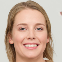 Joyful white young-adult female with long  brown hair and blue eyes