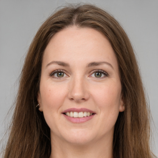 Joyful white young-adult female with long  brown hair and grey eyes