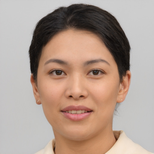 Joyful asian young-adult female with short  brown hair and brown eyes