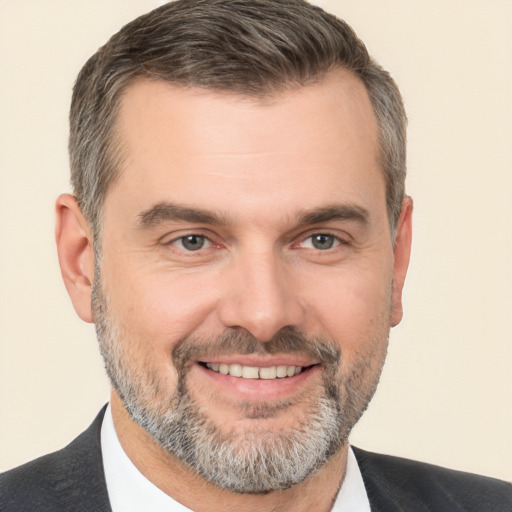 Joyful white adult male with short  brown hair and brown eyes